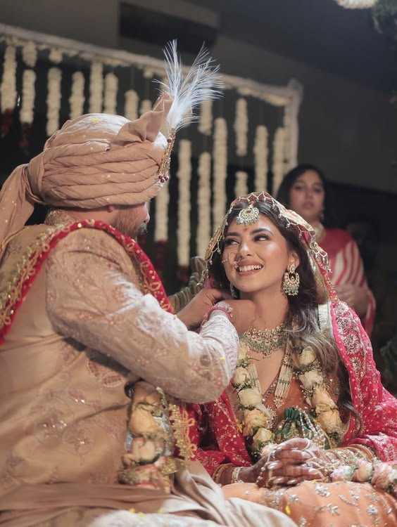 Groom adjusting bride's jewelry
